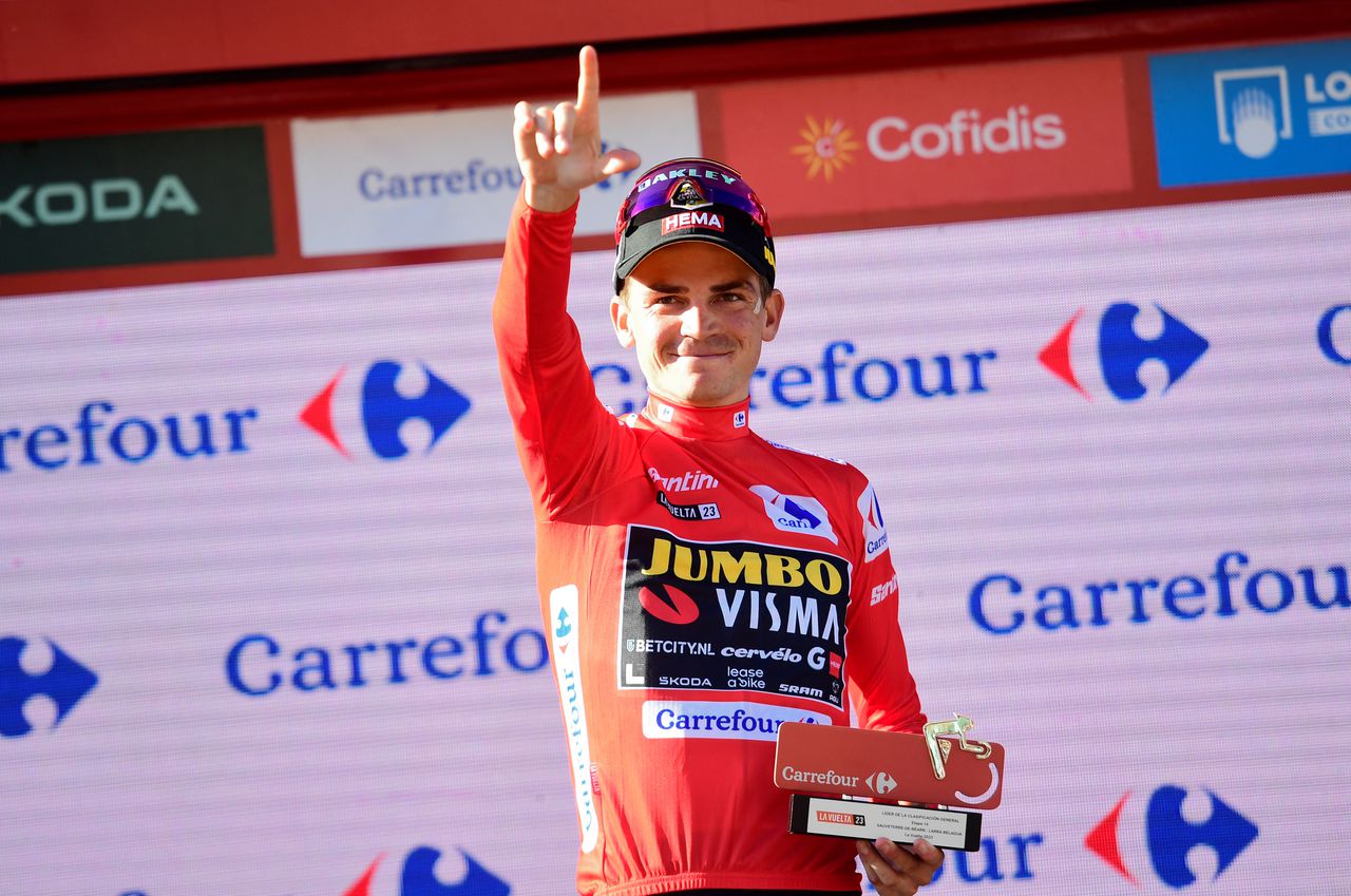 Team Jumbo-Visma's US rider Sepp Kuss wearing the overall leader's red jersey celebrates on the podium after the stage 14 of the 2023 La Vuelta cycling tour of Spain, a 156,2 km race between Sauveterre-de-Bearn and Larra Belagua, on September 9, 2023. (Photo by Ander GILLENEA / AFP)