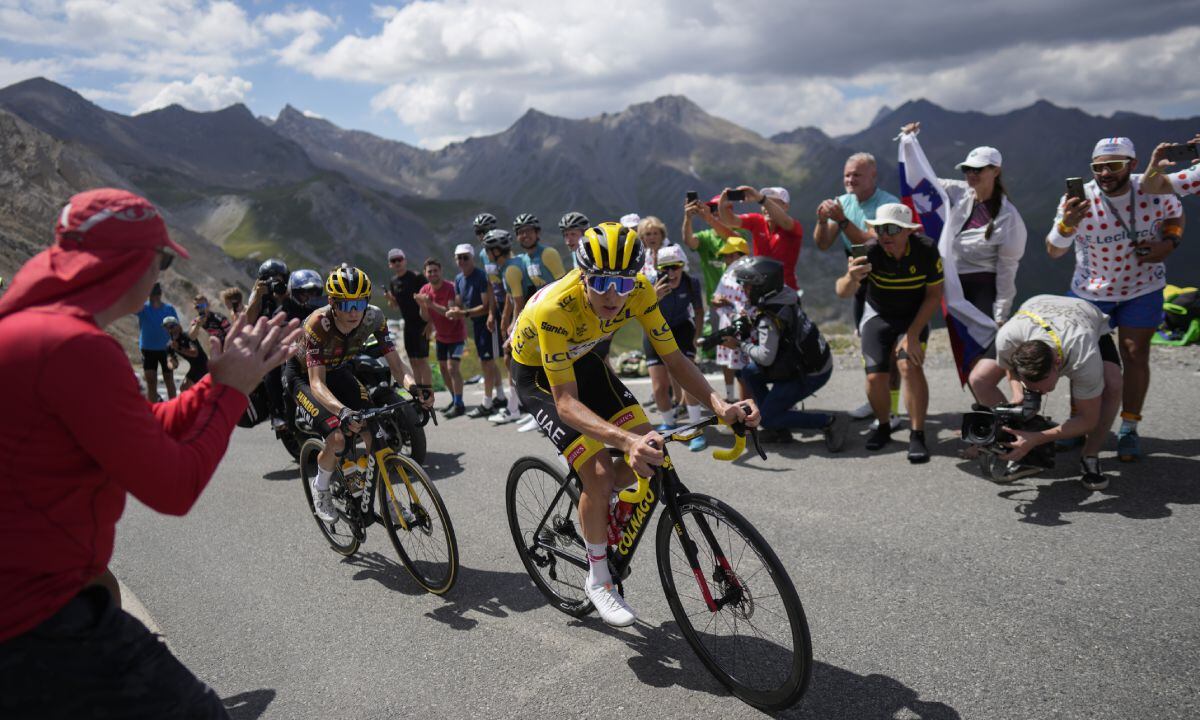 Stage winner and new overall leader Denmark's Jonas Vingegaard, left, and Slovenia's Tadej Pogacar, wearing the overall leader's yellow jersey, climb during the eleventh stage of the Tour de France cycling race over 152 kilometers (94.4 miles) with start in Albertville and finish in Col du Granon Serre Chevalier, France, Wednesday, July 13, 2022. (AP Photo/Thibault Camus)