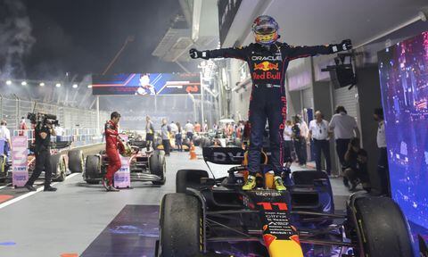 Red Bull driver Sergio Perez of Mexico stands on his car as he celebrate after winning the Singapore Formula One Grand Prix, at the Marina Bay City Circuit in Singapore, Sunday, Oct.2, 2022. (AP/Danial Hakim)