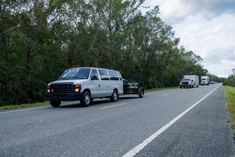 Ambulance cars convoy en route to assist after hurricane. Nature havoc in North Florida
