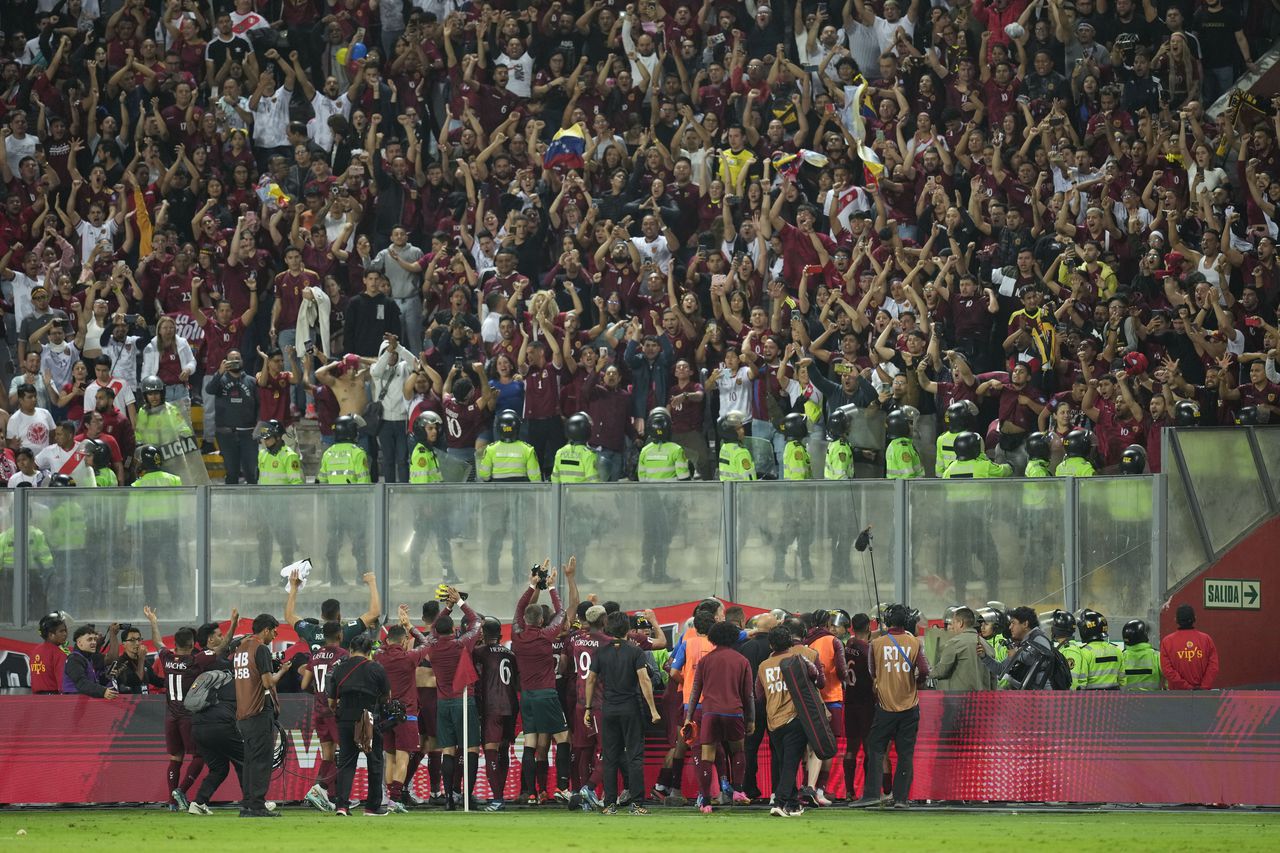 Venezuela players celebrate after draw with Peru 1-1 during a qualifying soccer match for the FIFA World Cup 2026 at the National stadium in Lima, Peru, Tuesday, Nov. 21, 2023. (AP Photo/Martin Mejia)