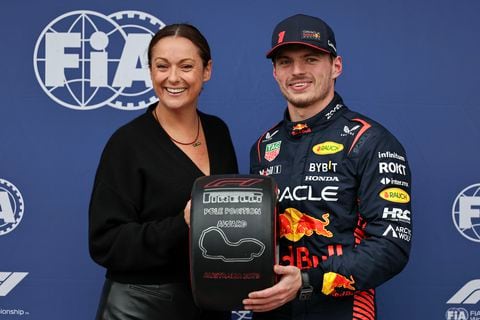 MELBOURNE, AUSTRALIA - APRIL 01: Max Verstappen of the Netherlands and Oracle Red Bull Racing (R) is presented with the Pirelli Pole Position trophy by Celeste Barber (L) after claiming pole position during qualifying ahead of the F1 Grand Prix of Australia at Melbourne Grand Prix Circuit on April 1, 2023 in Melbourne, Australia. (Photo by Qian Jun/MB Media/Getty Images)