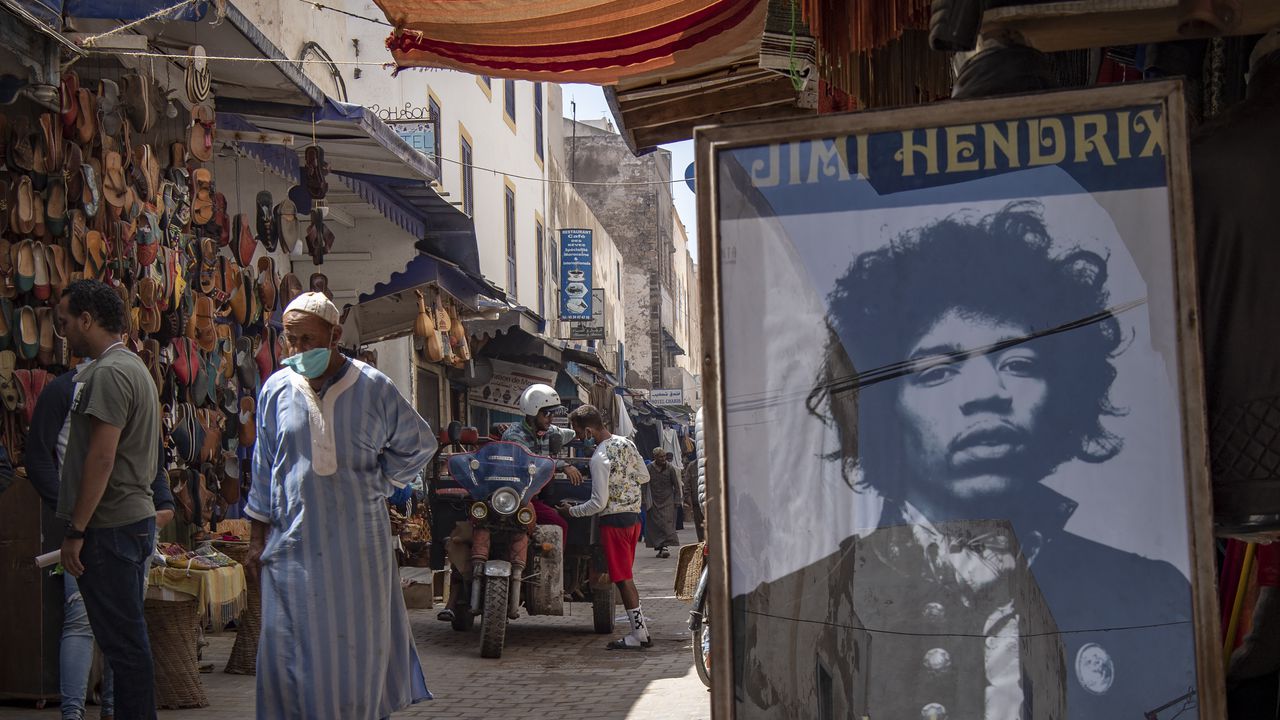 A picture taken in the Moroccan coastal city of Essaouira shows portraits of late US guitarist Jimi Hendrix on September 10, 2020. - Some claim to have seen him, others to have spoken with him -- 50 years after guitar legend Jimi Hendrix's untimely death, a village on Morocco's Atlantic coast pulsates with his memory. In the Summer of 1969, Hendrix, the pioneering US guitar wizard whose whose hits included "Purple Haze" and "Hey Joe", made a brief stop in Essaouira, a former fort town and latter day tourist magnet located five kilometres (three miles) from his childhood village. (Photo by FADEL SENNA / AFP)