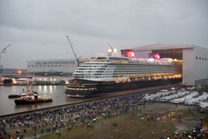 PAPENBURG, GERMANY - OCTOBER 30:  In this handout image provided by Disney, the new Disney cruise ship, the Disney Dream, made its very first public appearance Oct. 30, 2010, when it was pulled by tugboat out of the enclosed shipyard building where it was constructed at the Meyer Werft shipyard in Papenburg, Germany.  Thousands of local residents gathered for the ceremony which was highlighted by fireworks and Disney characters.  (Photo by Diana Zalucky/Disney via Getty Images)