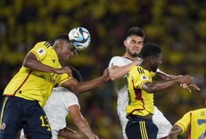 Colombia's Yerry Mina, left, heads the ball during a qualifying soccer match for the FIFA World Cup 2026 against Venezuela at Metropolitano stadium in Barranquilla, Colombia, Thursday, Sept. 7, 2023. (AP Photo/Fernando Vergara)