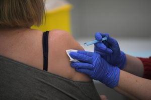 A woman receives a dose of the AstraZeneca's Covid-19 vaccine at a vaccination center on April 26, 2021 in Barcelona amid a campaign of vaccination to fight the spread of coronavirus. (Photo by LLUIS GENE / AFP)