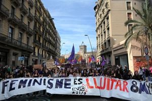 Los manifestantes sostienen una pancarta que dice "el feminismo está luchando" durante una manifestación con motivo del Día Internacional de la Mujer en Barcelona el 8 de marzo de 2023.  (Photo by LLUIS GENE / AFP)