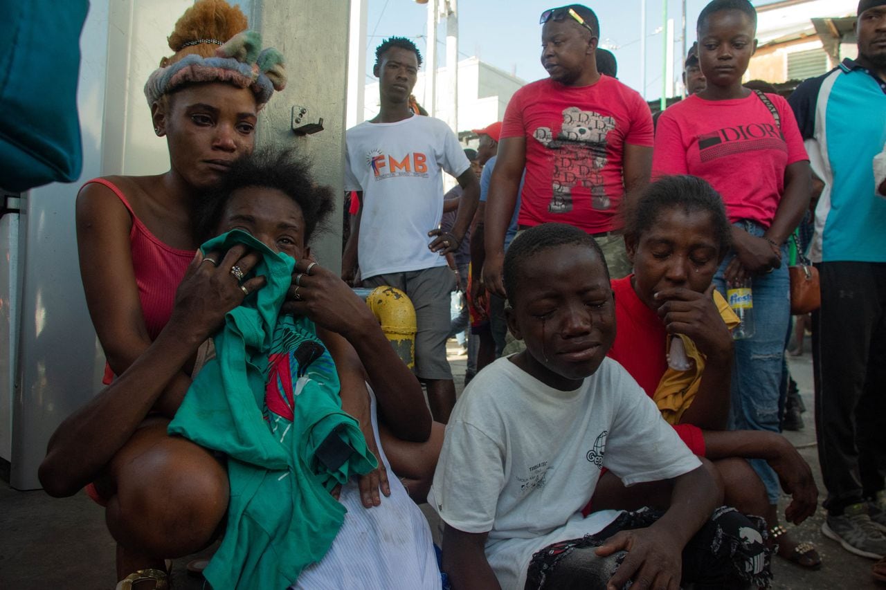 La gente reacciona después de que una docena de personas fueran asesinadas en la calle por pandilleros, en Pétionville, Puerto Príncipe, Haití, el 18 de marzo de 2024.