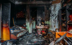 Burnt apartment house interior. Burned furniture. Consequences of fire concept.