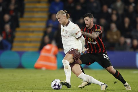 Bournemouth's Marcos Senesi, right, challenges Manchester City's Erling Haaland during the English Premier League soccer match between Bournemouth and Manchester City at the Vitality stadium in Bournemouth, England, Saturday, Feb. 24, 2024. (AP Photo/David Cliff)