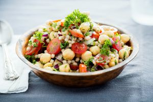 A chickpea and pearl couscous salad mixed with tomatoes, onions and herbs.
