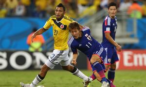 CUIABA, BRAZIL - JUNE 24: Yoichiro Kakitani of Japan fights off Carlos Valdes of Colombia during the 2014 FIFA World Cup Brazil Group C match between Japan and Colombia at Arena Pantanal on June 24, 2014 in Cuiaba, Brazil. (Photo by Elsa/Getty Images)