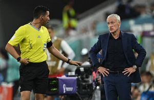 Soccer Football - FIFA World Cup Qatar 2022 - Round of 16 - France v Poland - Al Thumama Stadium, Doha, Qatar - December 4, 2022 France coach Didier Deschamps speaks to the fourth official Kevin Ortega REUTERS/Dylan Martinez