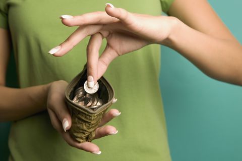 Close up of woman taking coin out of change purse