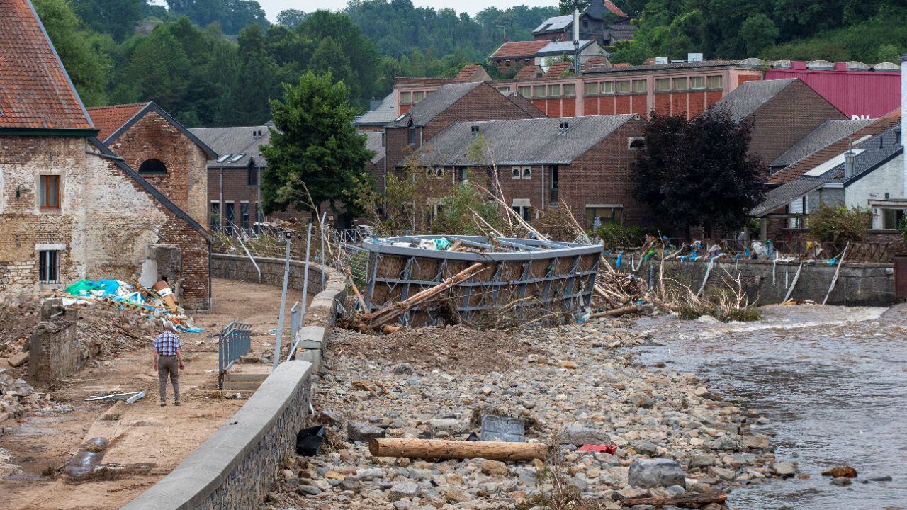 This photograph taken on July 24, 2021 shows a destroyed pedestrian bridge lying on the bank of the river Vesdre (Vesder-Weser), in the city centre of Limbourg, following last week's heavy rains and floodings. In mid-July western Europe was hit by devastating floods after torrential rains that ravaged entire villages and left at least 209 people dead in Germany and Belgium, as well as dozens missing. The flooding also caused damage in Luxembourg, the Netherlands and Switzerland.