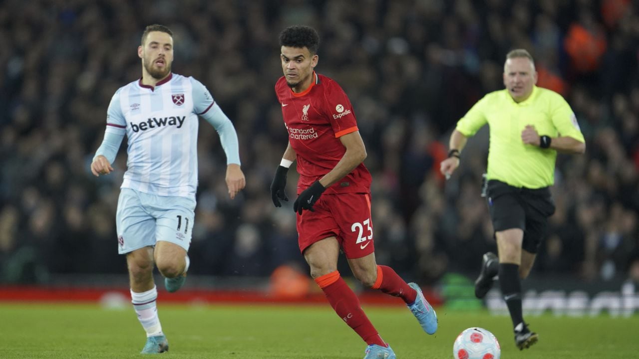 Liverpool's Luis Diaz, center, and West Ham's Nikola Vlasic, left, vie for the ball during the English Premier League soccer match between Liverpool and West Ham United at Anfield stadium in Liverpool, England, Saturday, March 5, 2022. (AP/Jon Super)