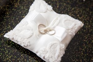 two wedding rings on a pillow