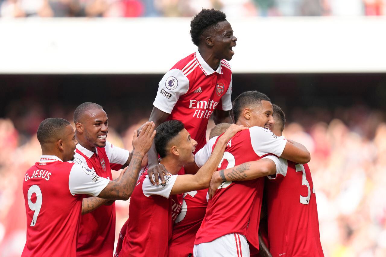 FILE - Arsenal players celebrate after their teammate Thomas Partey scored his side's opening goal during the English Premier League soccer match between Arsenal and Tottenham Hotspur, at Emirates Stadium, in London, England, Saturday, Oct. 1, 2022. Arsenal has revealed new artwork that will be displayed on the exterior of the Emirates Stadium. (AP Photo/Kirsty Wigglesworth, File)