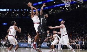Cleveland Cavaliers' Evan Mobley, center left, and Brooklyn Nets' Andre Drummond, center right, vie for a rebound during the second half of the opening basketball game of the NBA play-in tournament, Tuesday, April 12, 2022, in New York. The Nets won 115-108. (AP Photo/Seth Wenig)