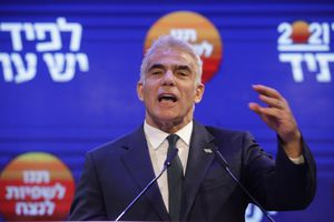 Yesh Atid party leader Yair Lapid speaks to his supporters after first exit poll results for the Israeli Parliamentary election at his party's headquarters in Tel Aviv, Israel, Wednesday, March. 24, 2021. (AP Photo/Sebastian Scheiner)