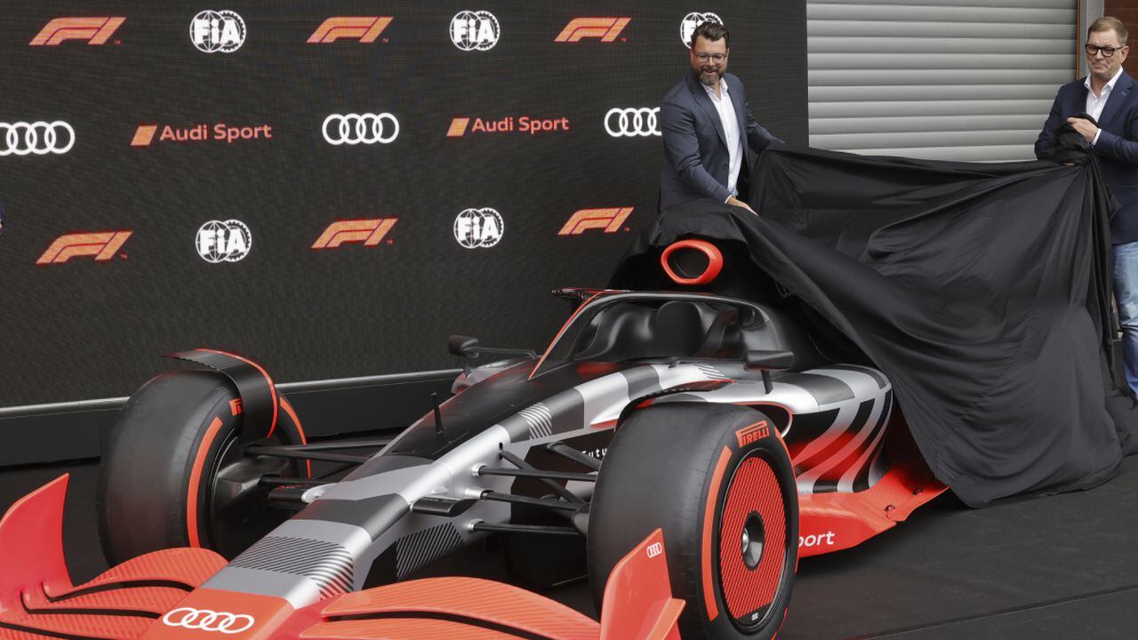 Audi CEO Markus Duesmann, right, and Audi's Chief Development Officer Oliver Hoffman unveil the new Audi F1 car during a media conference ahead of the Formula One Grand Prix at the Spa-Francorchamps racetrack in Spa, Belgium, Friday, Aug. 26, 2022. German manufacturer Audi will enter Formula One in 2026 in line with new engine regulations, chairman Markus Duesmann said on Friday. (AP/Olivier Matthys)