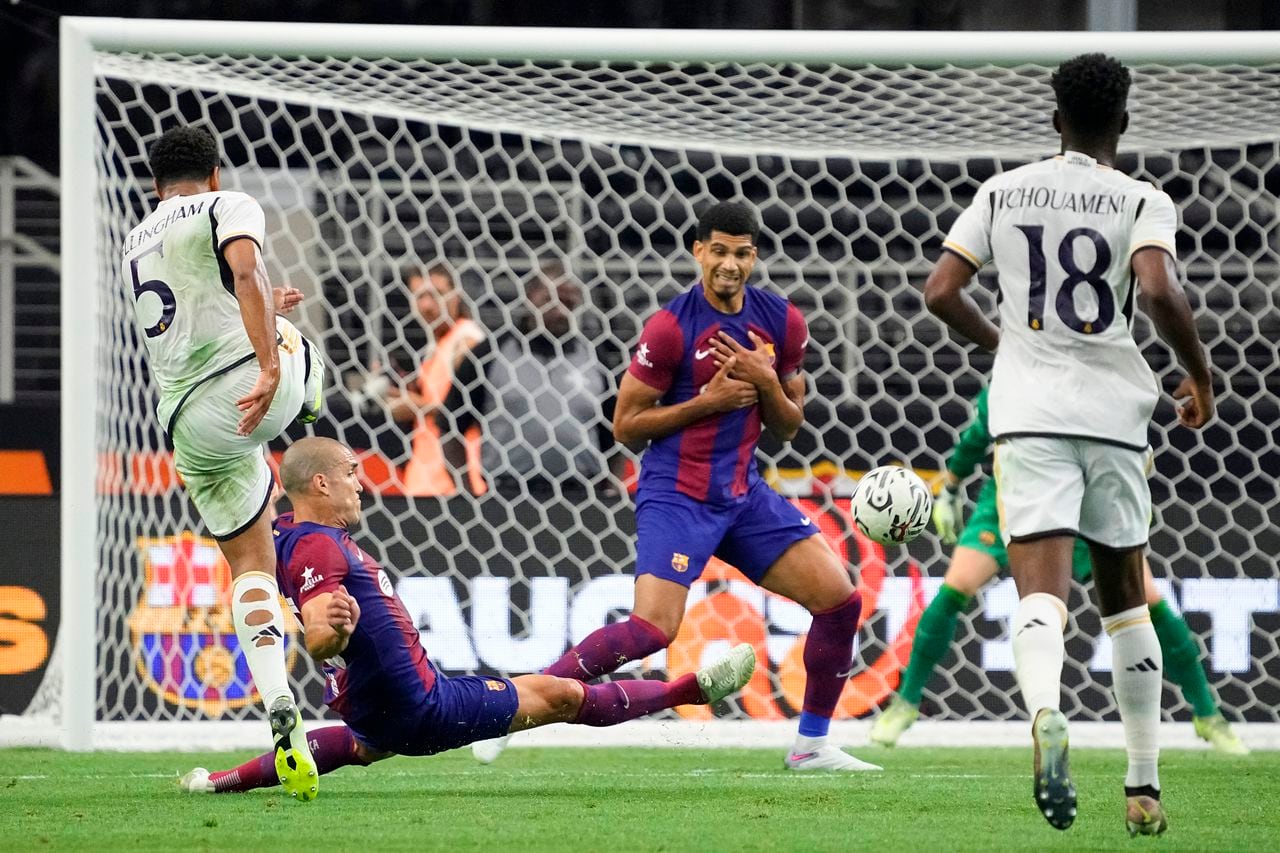 ARLINGTON, TEXAS - JULY 29: Oriol Romeu #18 of FC Barcelona slides to block a shot from Jude Bellingham #5 of Real Madrid during the first half of the pre-season friendly match at AT&T Stadium on July 29, 2023 in Arlington, Texas. (Photo by Sam Hodde/Getty Images)