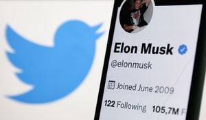 Elon Musk's Twitter profile displayed on a phone screen and Twitter logo displayed on a screen are seen in this illustration photo taken in Krakow, Poland on September 15, 2022. (Photo by Jakub Porzycki/NurPhoto via Getty Images)