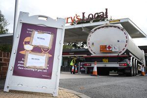 A fuel tanker arrives to replenish stocks at a petrol station in Coventry, central England on September 28, 2021. - The UK government today faced calls for nurses, police, teachers and other key workers to be given priority at petrol pumps, as the army was put on standby to ease a fuel supply crisis. (Photo by Paul ELLIS / AFP)