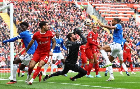 Soccer Football - Premier League - Liverpool v Everton - Anfield, Liverpool, Britain - October 21, 2023  Liverpool's Alisson in action with Everton's Dominic Calvert-Lewin REUTERS/Carl Recine NO USE WITH UNAUTHORIZED AUDIO, VIDEO, DATA, FIXTURE LISTS, CLUB/LEAGUE LOGOS OR 'LIVE' SERVICES. ONLINE IN-MATCH USE LIMITED TO 45 IMAGES, NO VIDEO EMULATION. NO USE IN BETTING, GAMES OR SINGLE CLUB/LEAGUE/PLAYER PUBLICATIONS.