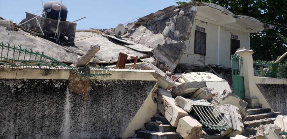 The residence of the Catholic bishop is damaged after an earthquake in Les Cayes, Haiti, Saturday, Aug. 14, 2021. (AP Photo/Delot Jean)