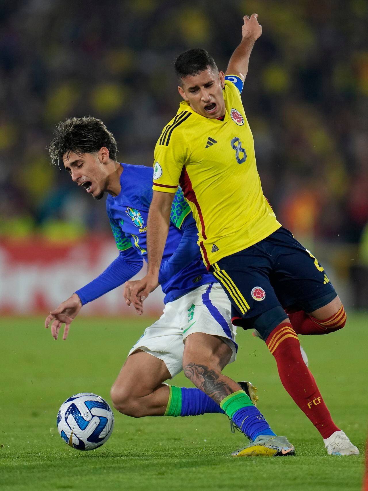 Brazil's Marlon Gomes, left, and Colombia's Gustavo Puerta struggle for the ball during a South America U-20 Championship soccer match in Bogota, Colombia, Thursday, Feb. 9, 2023. (AP Photo/Fernando Vergara)