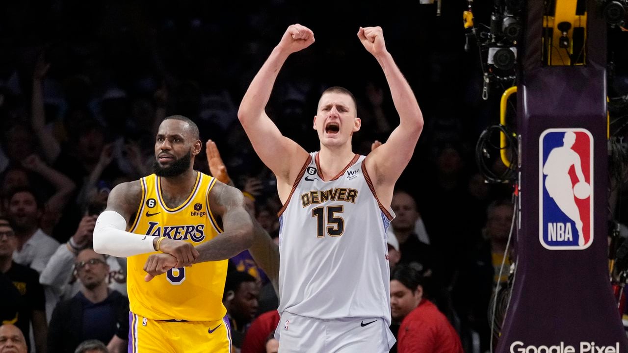 Denver Nuggets center Nikola Jokic (15) celebrates after Los Angeles Lakers forward LeBron James, left, missed a layup attempt as time expired in the second half of Game 4 of the NBA basketball Western Conference Final series Monday, May 22, 2023, in Los Angeles. Denver won 113-111 to win the series. (AP Photo/Ashley Landis)