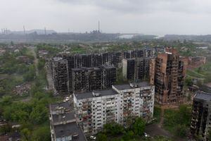 Una vista aérea de los edificios residenciales dañados y la planta de acero Azovstal al fondo en la ciudad portuaria de Mariupol el 18 de mayo de 2022, en medio de la acción militar rusa en curso en Ucrania. (Foto de Andrey BORODULIN / AFP)