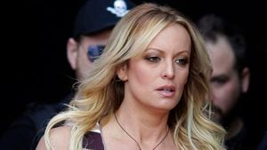 FILE - Adult film actress Stormy Daniels arrives for the opening of the adult entertainment fair Venus in Berlin, Oct. 11, 2018. A lawyer for Donald Trump said Thursday, March 30, 2023, that he has been told that the former president has been indicted in New York on charges involving payments to Daniels made during the 2016 presidential campaign to silence claims of an extramarital sexual encounter. (AP Photo/Markus Schreiber, File)