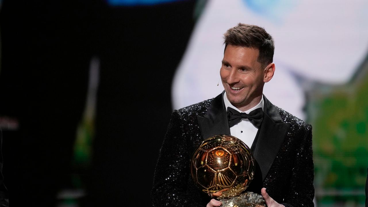 PSG player Lionel Messi reacts after winning the 2021 Ballon d'Or trophy during the 65th Ballon d'Or ceremony at Theatre du Chatelet, in Paris, Monday, Nov. 29, 2021. Messi won the Ballon d'Or for seventh time. (AP Photo/Christophe Ena)