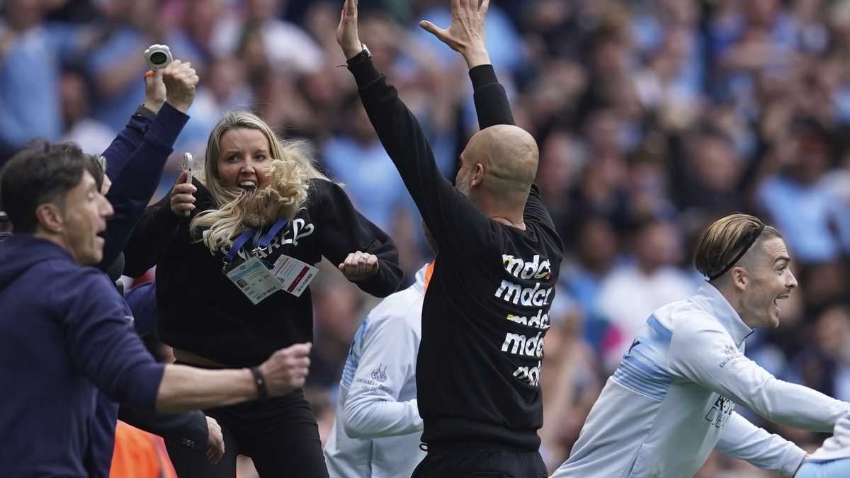 Manchester City's head coach Pep Guardiola and his teammates celebrate after winning the English Premier League soccer match between Manchester City and Aston Villa at the Etihad Stadium in Manchester, England, Sunday, May 22, 2022. Manchester City won the match against Aston Villa and secured the 2022 Premier League title. (AP Photo/Dave Thompson)