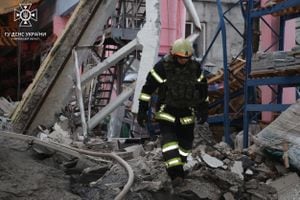 This handout photograph taken and released by the State Emergency Service of Ukraine on December 29, 2023, shows a Ukrainian firefighter working at a site after a rocket attack in the city of Kharkiv, amid the Russian invasion of Ukraine. Russia launched drone and missile strikes across Ukraine on December 29, 2023, killing at least 12 people and wounding over 70 in one of the biggest air attacks of the war. (Photo by Handout / State Emergency Service of Ukraine / AFP) / RESTRICTED TO EDITORIAL USE - MANDATORY CREDIT "AFP PHOTO / HO/ State Emergency Service of Ukraine" - NO MARKETING NO ADVERTISING CAMPAIGNS - DISTRIBUTED AS A SERVICE TO CLIENTS
