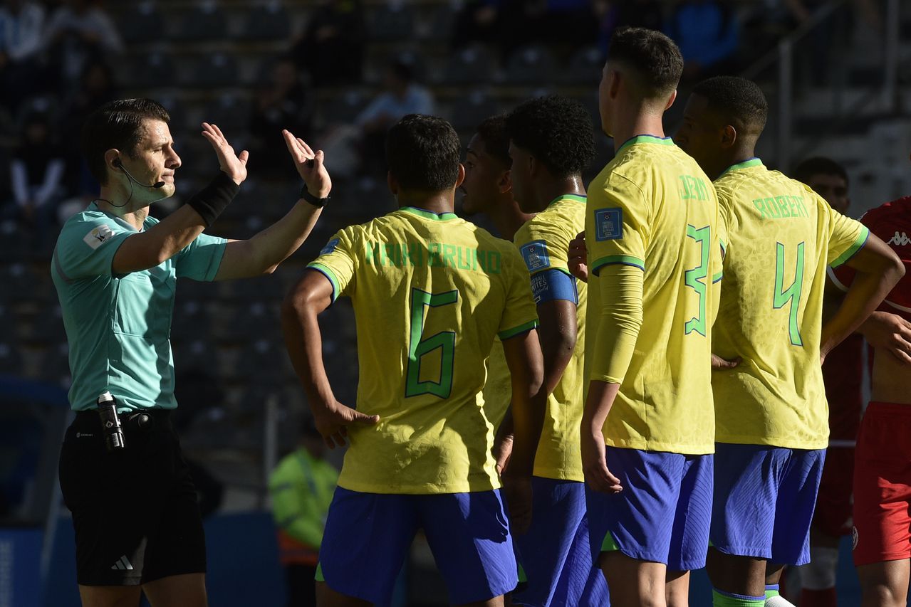 Players of Brazil remonstrate with referee Halil Umut Meler of Turkey, after he showed a red card to Brazil's Robert Renan during a FIFA U-20 World Cup round of 16 soccer match against Tunisia at La Plata Stadium in La Plata, Argentina, Wednesday, May 31, 2023. (AP Photo/Gustavo Garello)