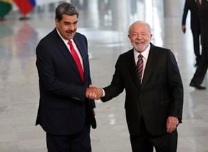 Brazilian President Luiz Inacio Lula da Silva, right, shakes hands with Venezuela's President Nicolas Maduro prior to their bilateral meeting at Planalto palace in Brasilia, Brazil, Monday, May 29, 2023. Maduro is in Brazil for the Union of South American Nations (UNASUR) summit that starts on Tuesday. (AP Photo/Gustavo Moreno)