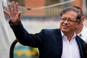 Gustavo Petro, left, presidential candidate with the Historical Pact coalition, waves upon his arrival to a polling station to vote in presidential elections in Bogota, Colombia, Sunday, May 29, 2022. (AP Photo/Fernando Vergara)