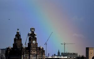 (FILES) In this file photo taken on March 06, 2019 a partial rainbow is pictured over the Royal Liver Building in Liverpool, north-west England. - Britain on July 21, 2021 expressed grave disappointment after the UN's cultural agency UNESCO voted to remove Liverpool from its list of world heritage sites because of overdevelopment. (Photo by Paul ELLIS / AFP)