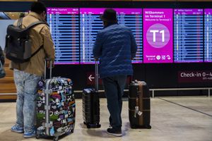 Los pasajeros miran un tablero que muestra todos los vuelos cancelados durante una huelga de advertencia en el aeropuerto BER de Berlín-Brandenburgo en Schoenefeld, Alemania, el miércoles 25 de enero de 2023. (Christoph Soeder/dpa via AP)
