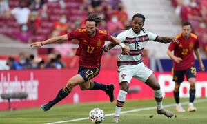 Spain's Fabian Ruiz, left, gets past Portugal's Renato Sanches during the international friendly soccer match between Spain and Portugal at the Wanda Metropolitano stadium in Madrid, Spain on Friday June 4, 2021. (AP Photo/Manu Fernandez)