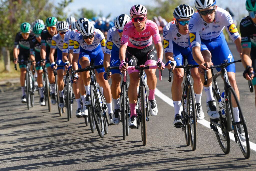 Portugal's Joao Almeida wears the pink jersey of the race overall leader as he pedals in the pack during the sixth stage of the Giro d'Italia cycling race, from Castrovillari to Matera, southern Italy, Thursday, Oct. 8, 2020. (Fabio Ferrari/LaPresse via AP)