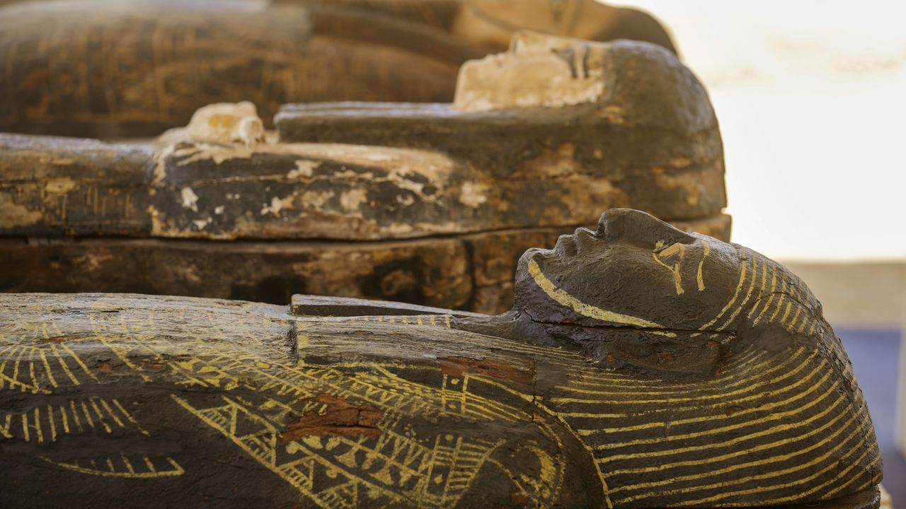 Painted coffins with well-preserved mummies inside, dating back to the Late Period of ancient Egypt around 500 B.C, are displayed at a makeshift exhibit at the feet of the Step Pyramid of Djoser in Saqqara, 24 kilometers (15 miles) southwest of Cairo, Egypt, Monday, May 30, 2022. (AP Photo/Amr Nabil)