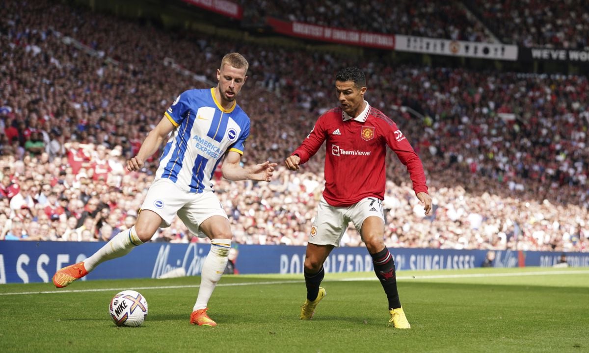 Brighton's Adam Webster, left, challenges for the ball with Manchester United's Cristiano Ronaldo during the English Premier League soccer match between Manchester United and Brighton at Old Trafford stadium in Manchester, England, Sunday, Aug. 7, 2022. (AP/Dave Thompson)