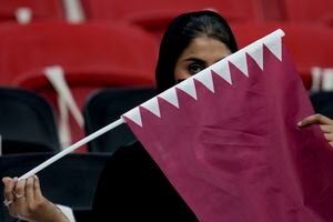 A Qatari fan holds the Qatar national flag prior to the World Cup, group A soccer match between Qatar and Ecuador at the Al Bayt Stadium, in Al Khor, Sunday, Nov. 20, 2022. (AP Photo/Natacha Pisarenko)