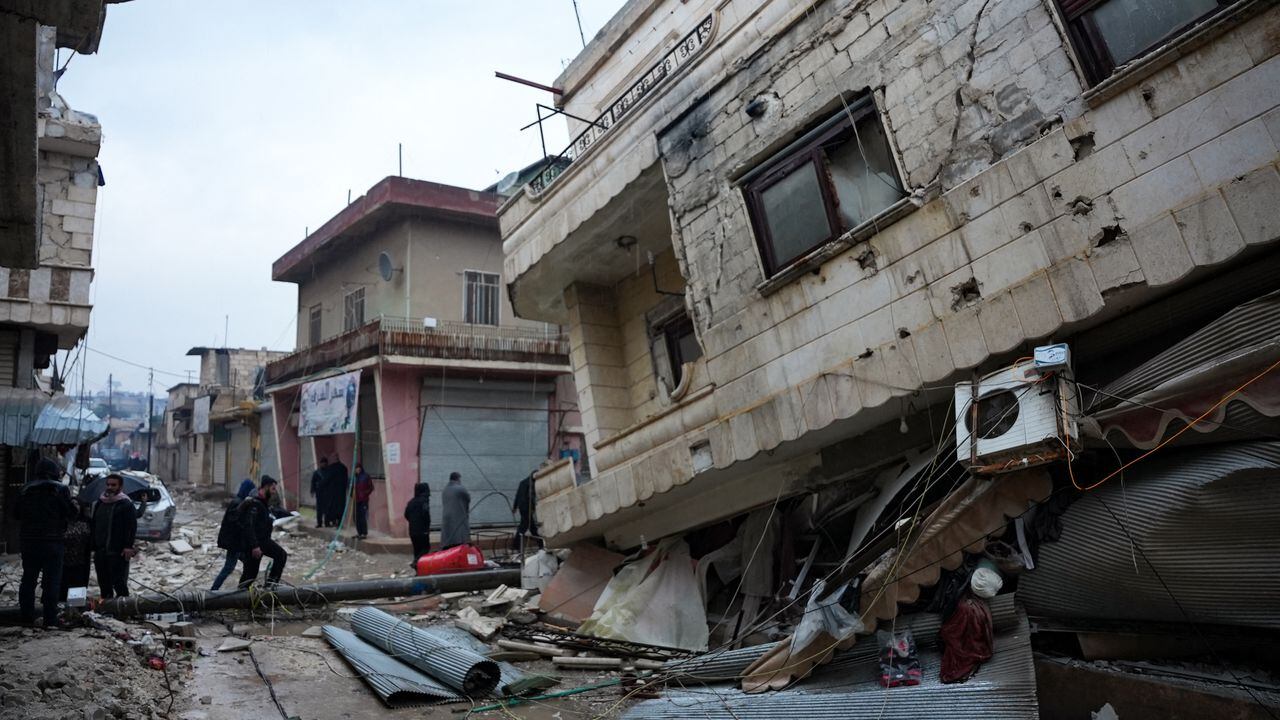 Los residentes caminan a lo largo de un edificio derrumbado luego de un terremoto en la ciudad de Jandaris, en el campo de la ciudad de Afrin, en el noroeste de Siria, en la parte rebelde de la provincia de Alepo, el 6 de febrero de 2023. un terremoto de magnitud 7,8 que se originó en Turquía y se sintió en los países vecinos.