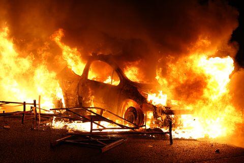 A vehicle burns, destroyed by protesters in Nanterre, west of Paris, on June 27, 2023, after French police killed a teenager who refused to stop for a traffic check in the city. The 17-year-old was in the Paris suburb early on June 27 when police shot him dead after he broke road rules and failed to stop, prosecutors said. The event has prompted expressions of shock and questions over the readiness of security forces to pull the trigger. (Photo by Zakaria ABDELKAFI / AFP)