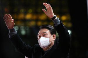 El candidato presidencial de Corea del Sur, Yoon Suk-yeol, del principal opositor Partido del Poder Popular, hace gestos a sus seguidores durante un mitin de campaña electoral en Seúl el 8 de marzo de 2022, antes de las elecciones presidenciales del 9 de marzo. (Photo by HONG Yoon-gi / AFP)